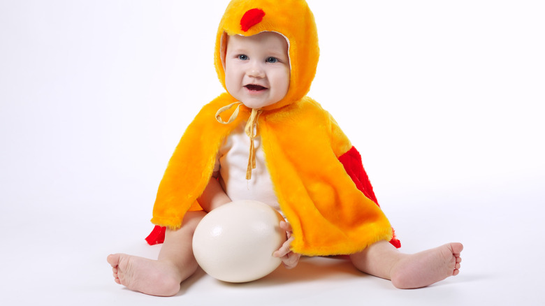 Smiling baby in chicken costume