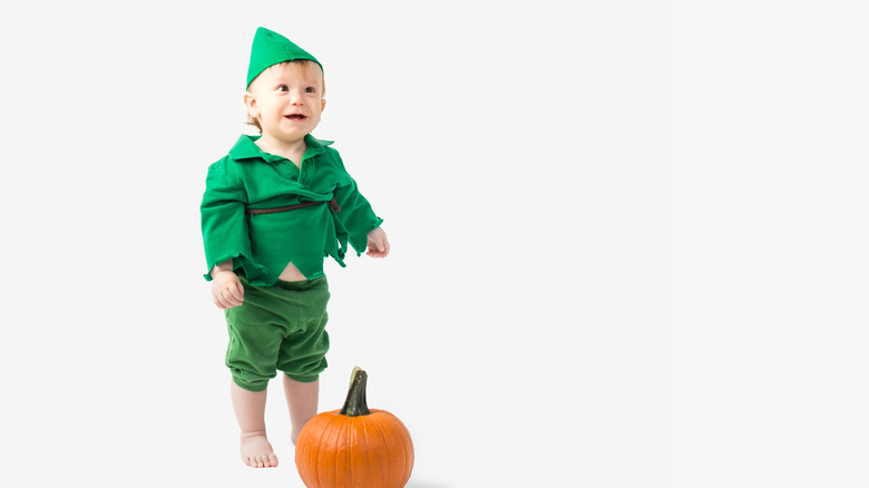 Smiling tot dressed as Peter Pan