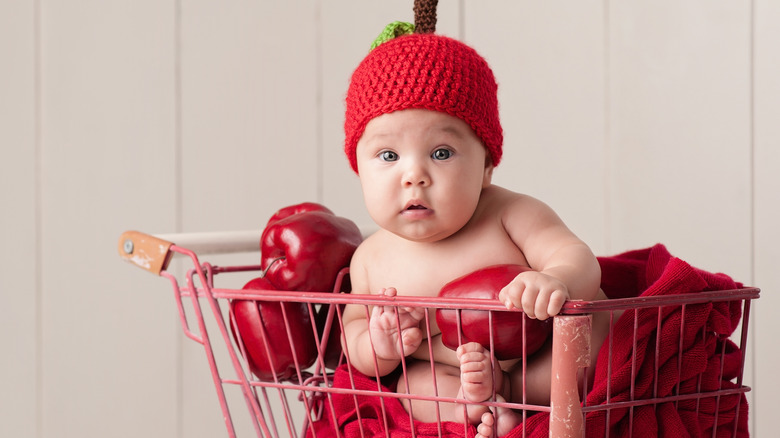 Adorable baby in apple costume