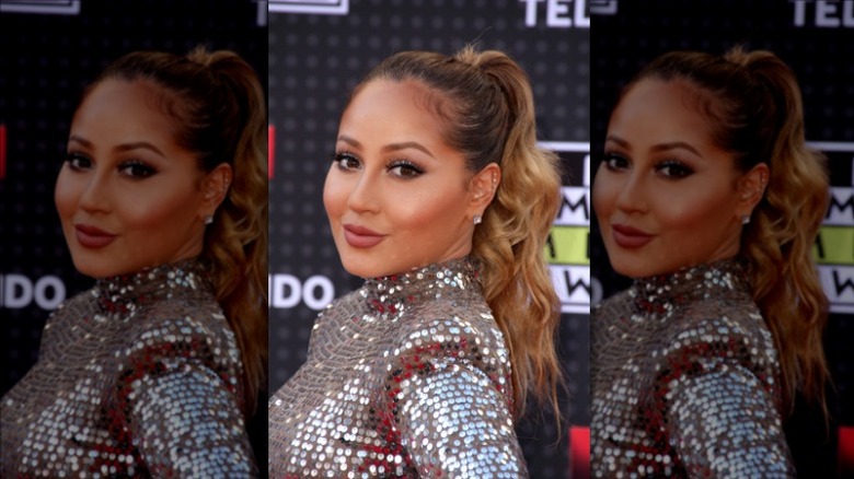 Adrienne Bailon-Houghton posing at 2015 awards show