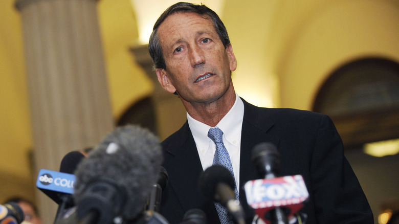 Mark Sanford speaking into media microphones