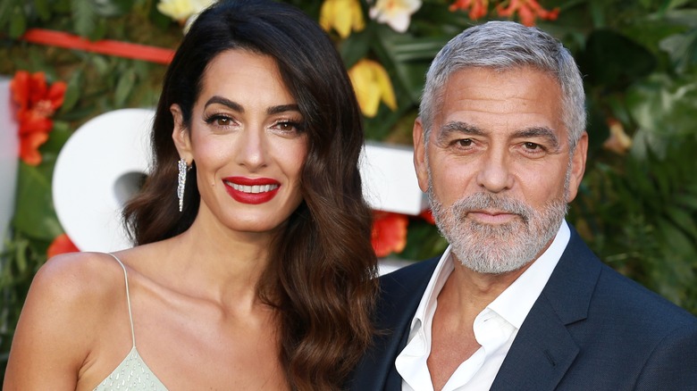 George and Amal Clooney smiling at camera