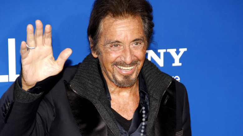 Al Pacino smiling and waving