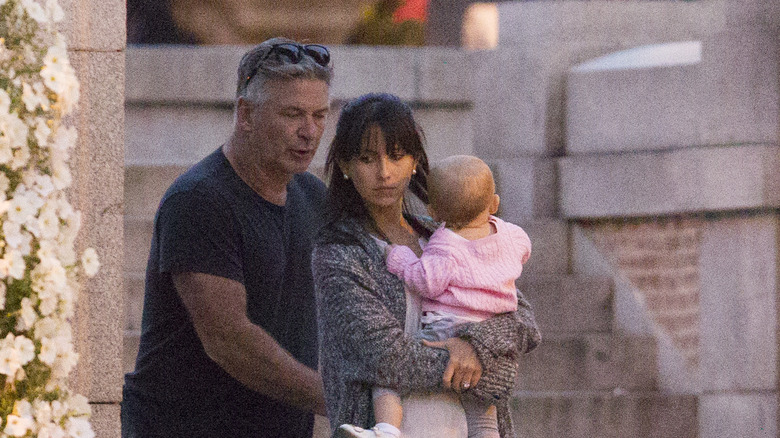 Hilaria Baldwin and Alec Baldwin walking with Carmen Baldwin