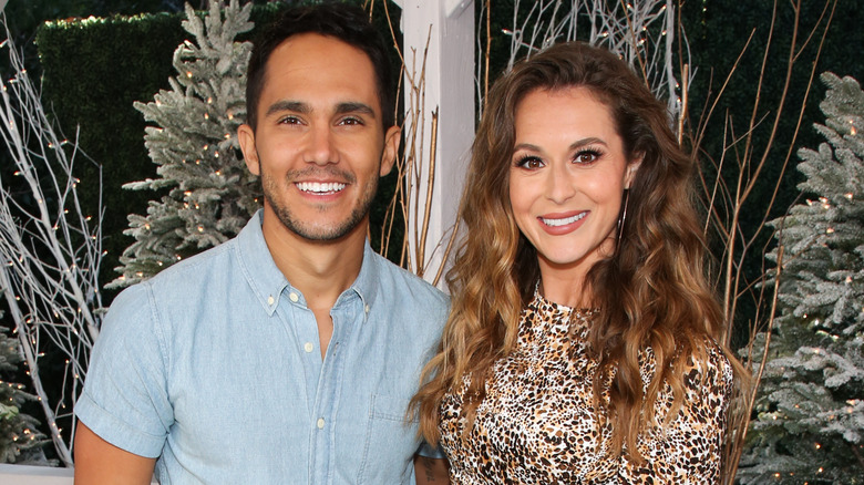 Carlos and Alexa PenaVega with twinkly trees