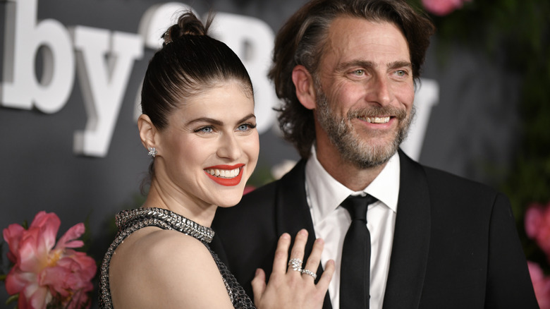 Alexandra Daddario and Andrew Form smiling on the Baby2Baby gala red carpet