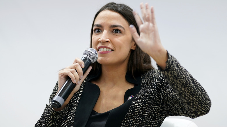 Alexandria Ocasio-Cortez giving advice on stage