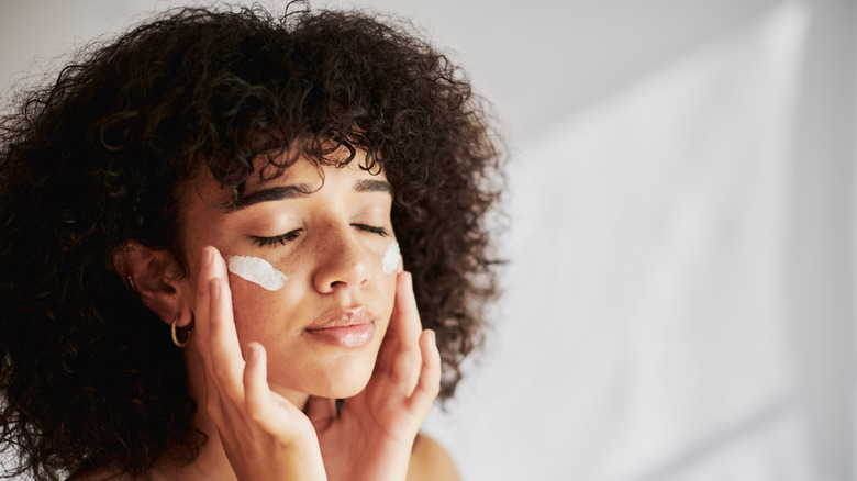 woman applying face cream