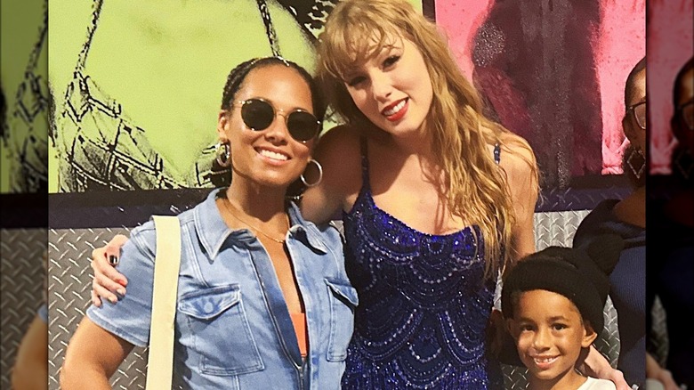 Alicia Keys, Taylor Swift, and Genesis Dean smiling