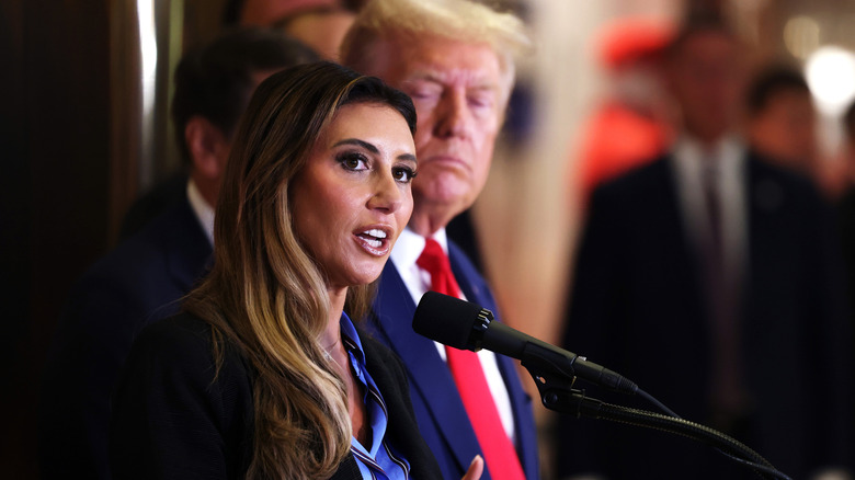 Alina Habba with Trump in background