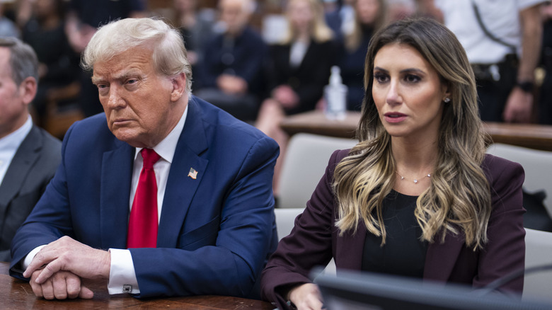 President Donald Trump sits alongside Alina Habba in a courtroom