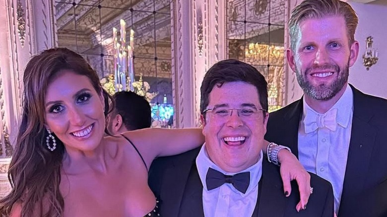 Alina Habba, Ryan Hager, and Eric Trump pose together at a New Years Eve party at Mar-A-Lago (2022)