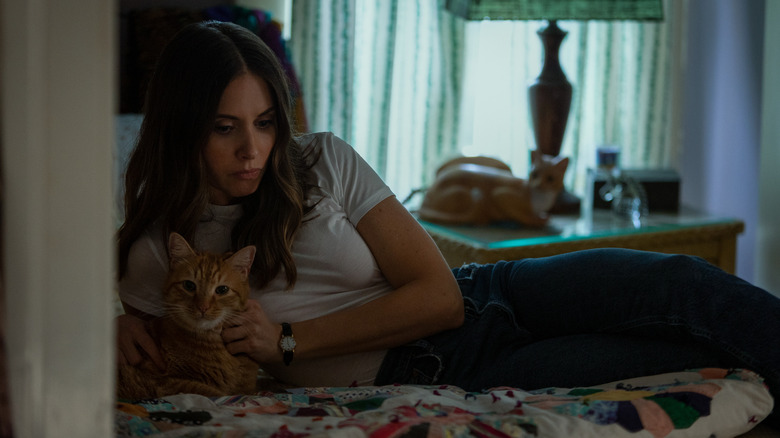 Alison Brie petting cat in Somebody I Used to Know