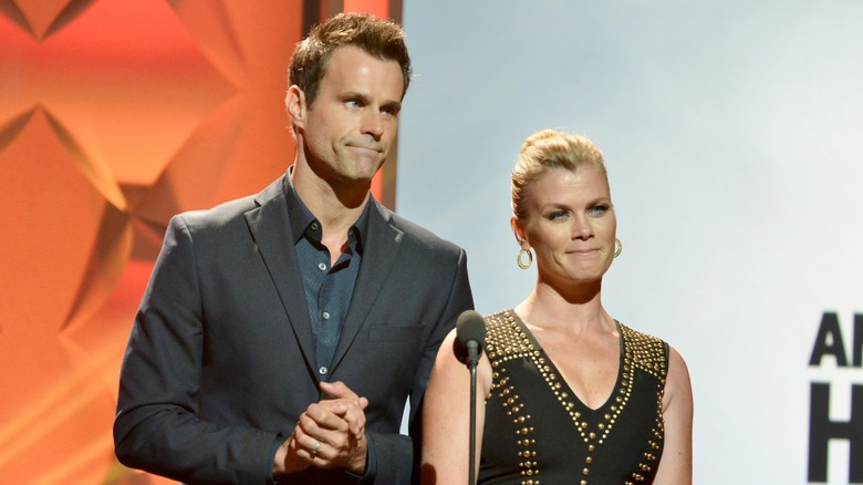 Cameron Mathison and Alison Sweeney standing at microphone