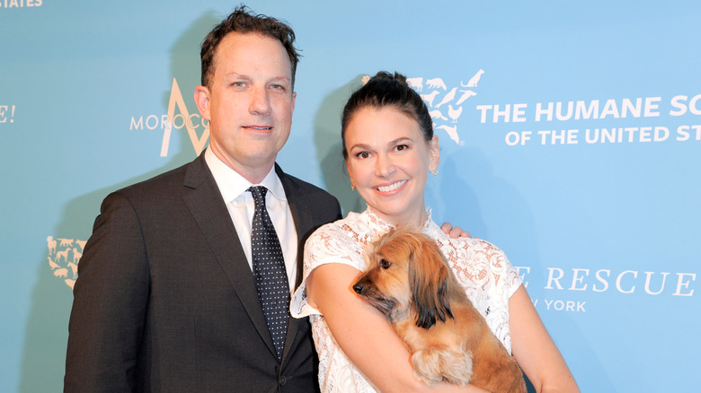 Ted Griffin and Sutton Foster holding a puppy