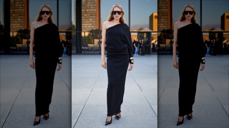 Woman posing in black dress and heels