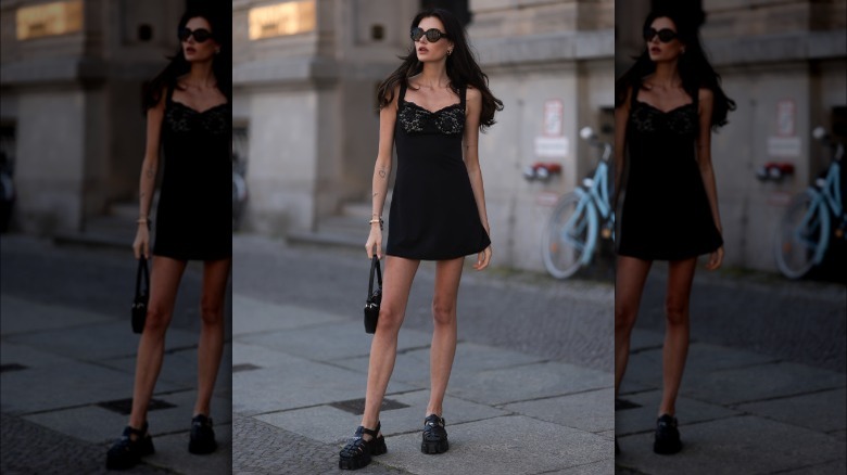 Woman wearing black loafers and slip dress