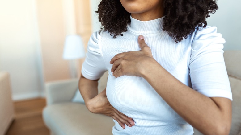 A new mom massaging her breast to stimulate lactation