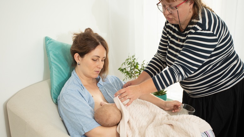 A lactation consultant helping mother