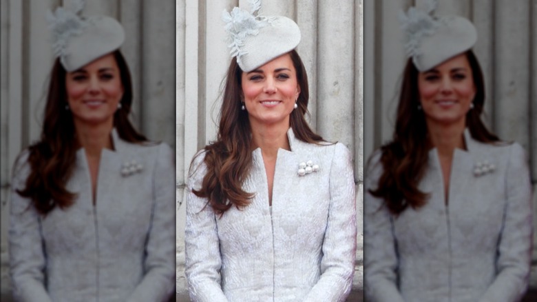 Princess Catherine smiling in silver-blue dress and hat