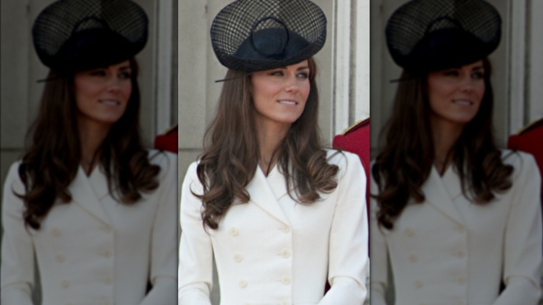 Princess Catherine in white dress and black fascinator on balcony