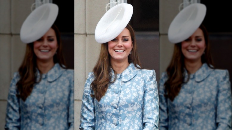 Princess Catherine laughing in white hat and blue dress