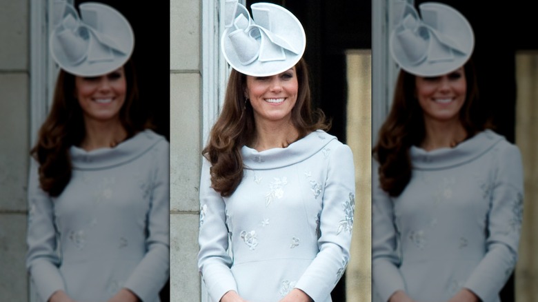 Princess Catherine smiling in blue dress and fascinator on balcony