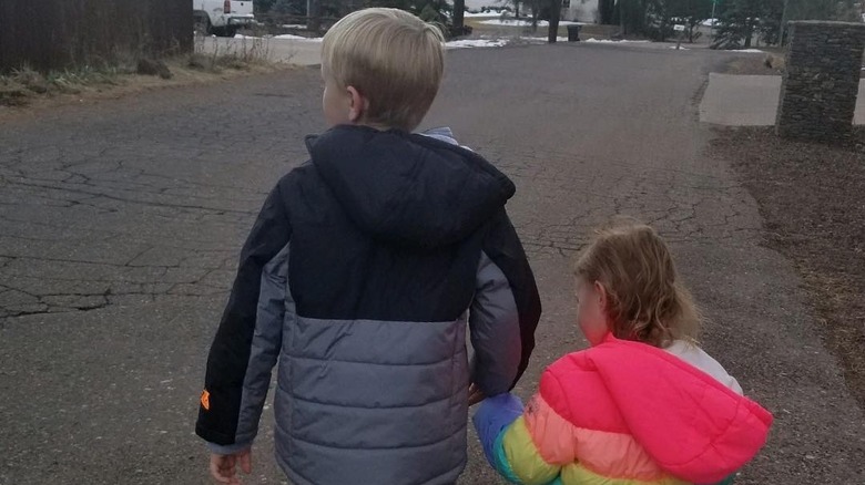 Solomon and Ariella Brown hold hands on street