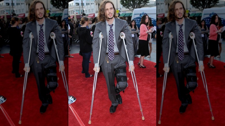 Matthew Gray Gubler walking on crutches