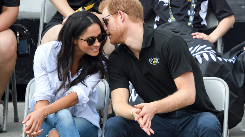 Prince Harry whispers in Meghan Markle's ear