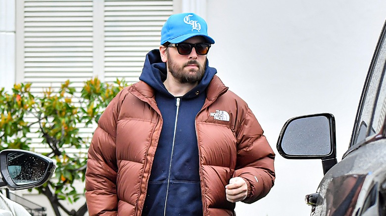 Scott Disick wearing hat and shades