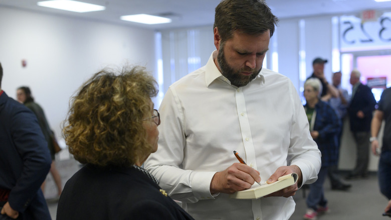 JD Vance signing his book "Hillbilly Elegy" for a supporter, 2022.