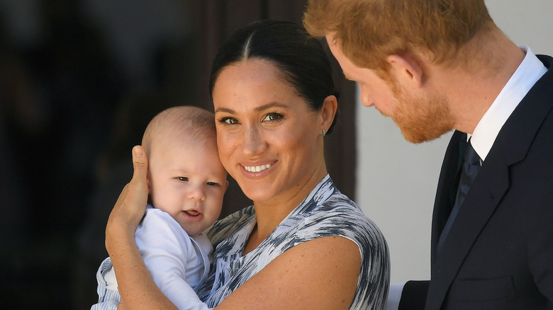 Meghan Markle holding Prince Archie with Prince Harry