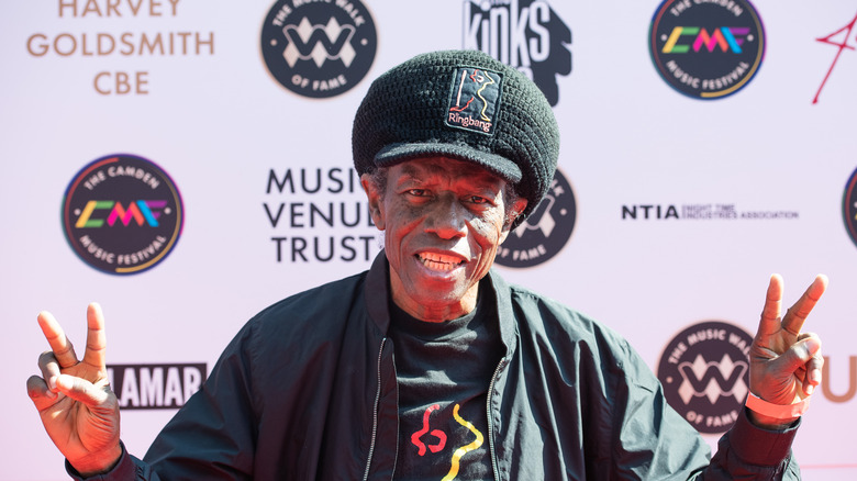 Eddy Grant holding up peace signs