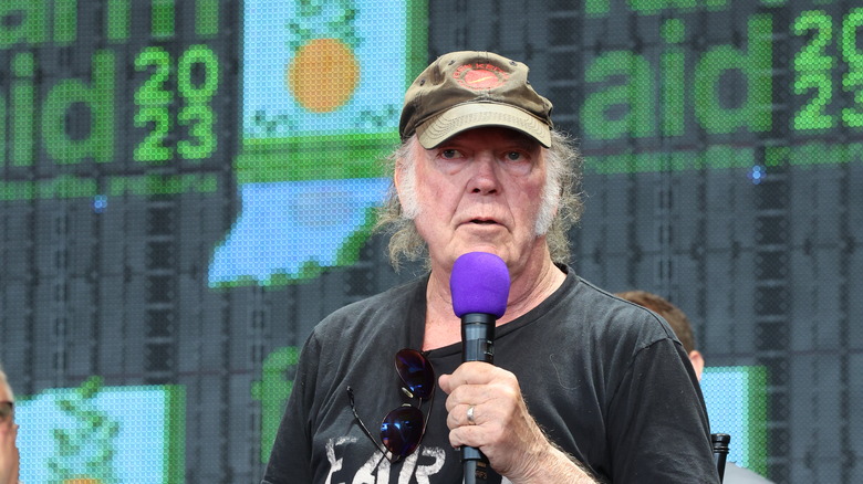 Neil Young holding a microphone