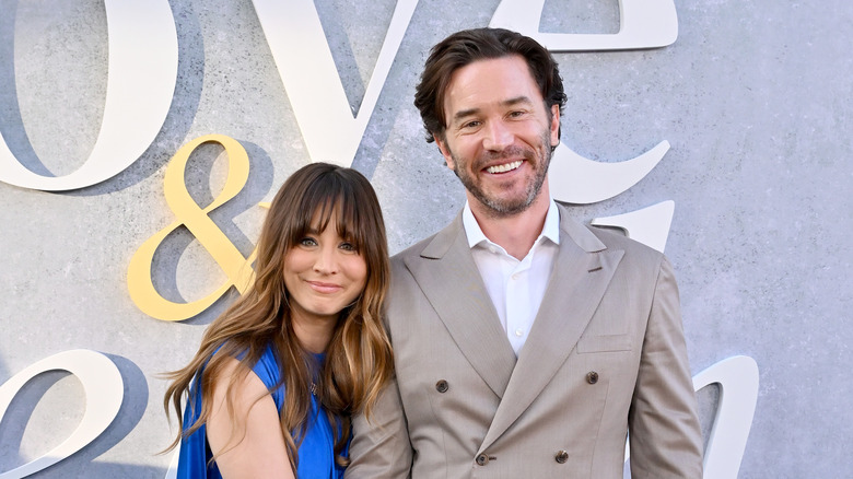 Kaley Cuoco and Tom Pelphrey smiling on red carpet