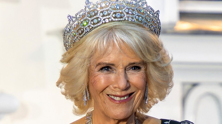 Queen Camilla smiling in tiara