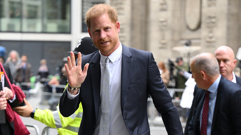 Prince Harry waving outside court