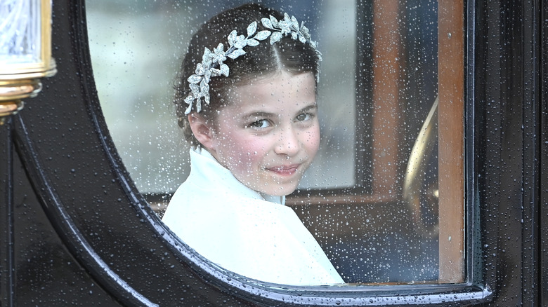 Princess Charlotte looking out carriage window wearing leaf tiara