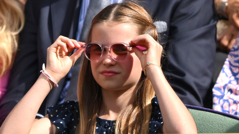 Princess Charlotte adjusting her pink sunglasses