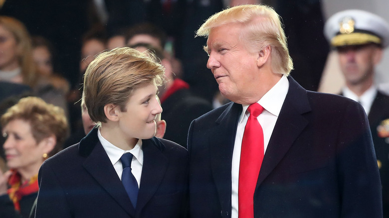 Barron and Donald Trump regarding each other