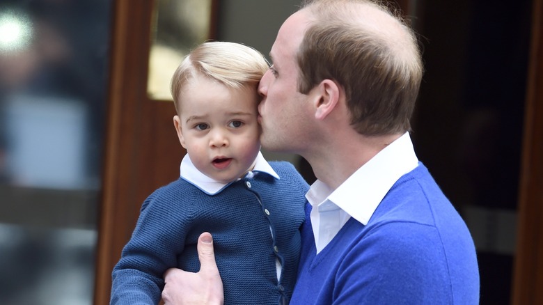 Prince William kissing Prince George 