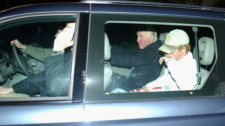 Prince Harry in car surrounded by paparazzi