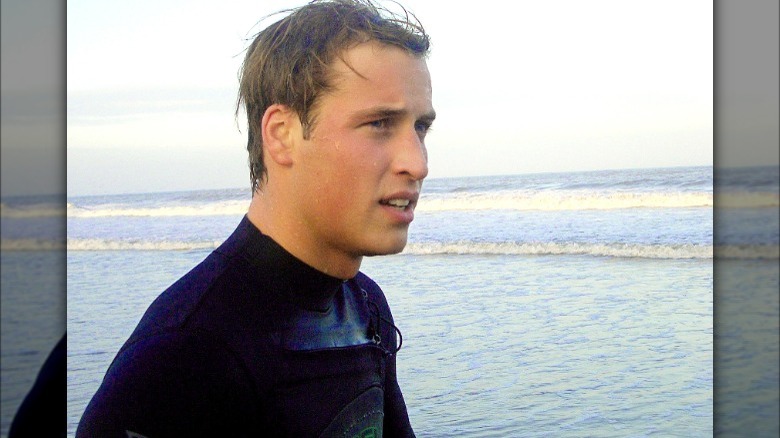 Prince William on a beach after surfing 