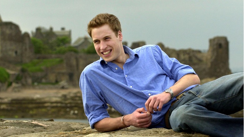 Prince William laying on the beach in St Andrews