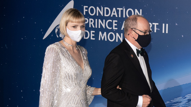 Prince Albert and Charlene in masks