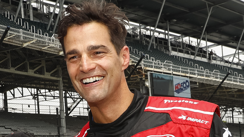 Rob Marciano posing in a Honda racing outfit 