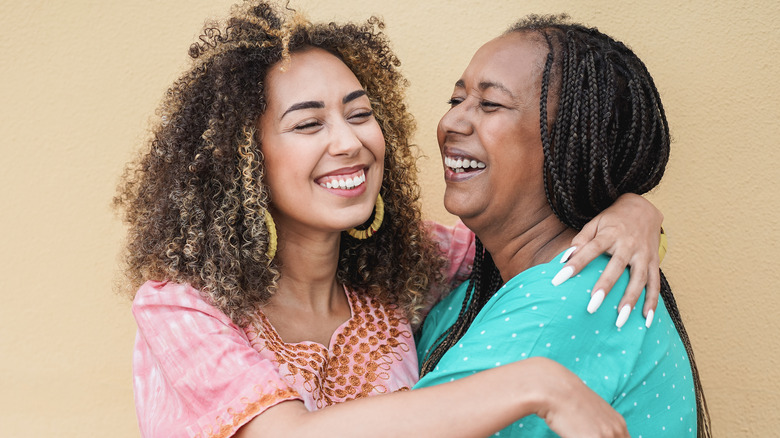 Curly-haired woman hugging