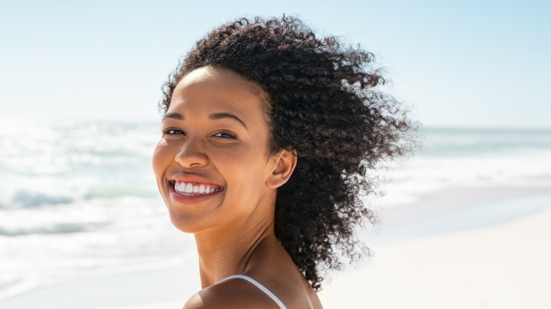 Curly-haired woman smiling 