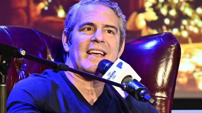 Andy Cohen front of Sirius XM microphone